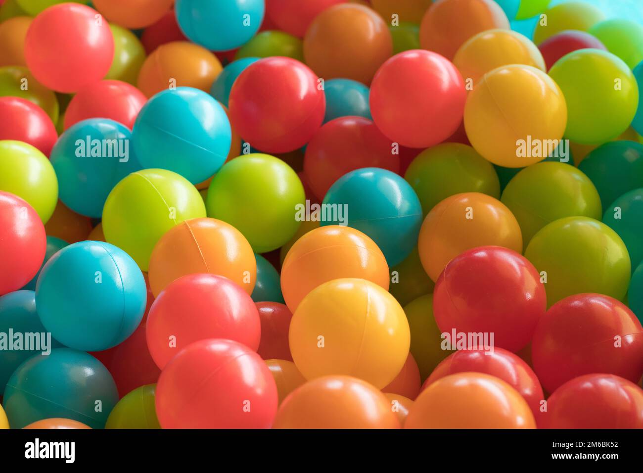 Multi colored, highly saturated plastic balls, in softplay ballpit