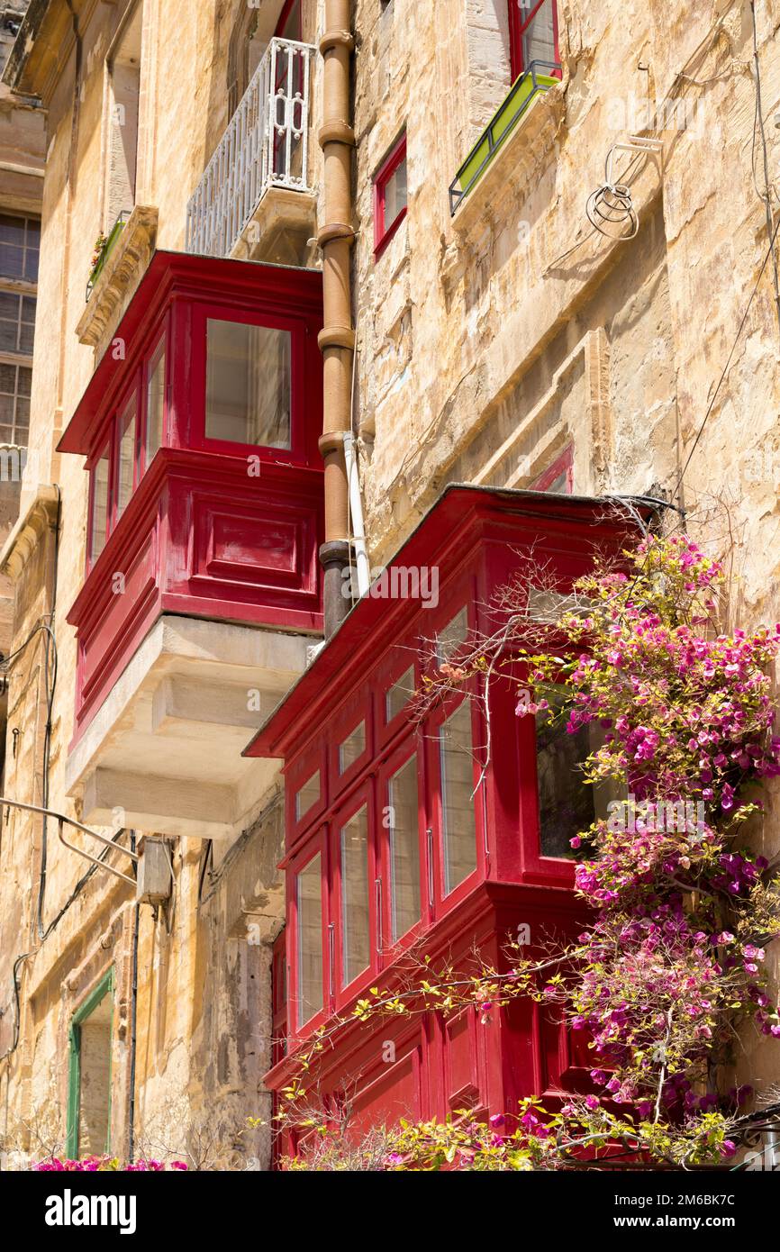 Red traditional wooden Maltese balconies in Valletta Stock Photo