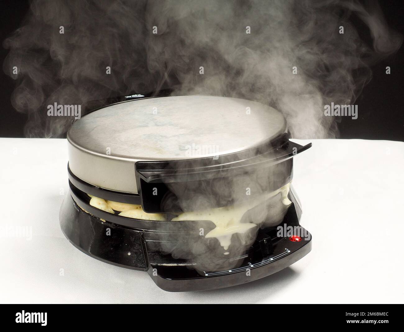 Steaming hot waffle maker Stock Photo Alamy