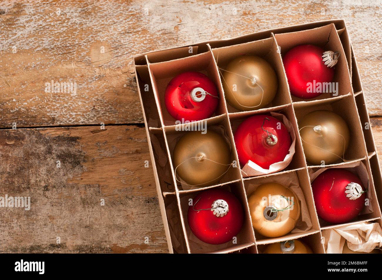 Shiny red and gold holiday ornaments in box Stock Photo