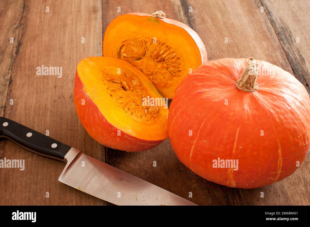 Small round oddly shaped pumpkin cut in middle Stock Photo