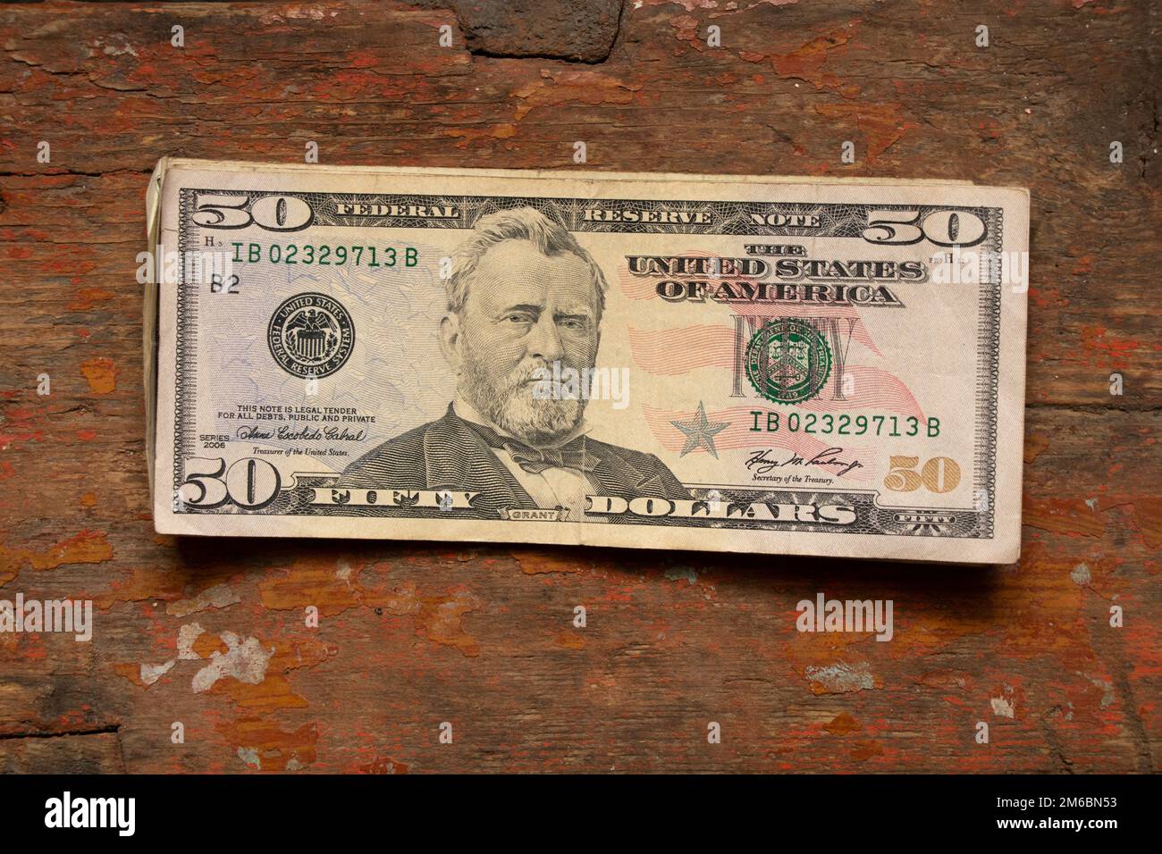 Closeup Of Fifty Dollar Bills On Wooden Table. Fifty Dollar Stock