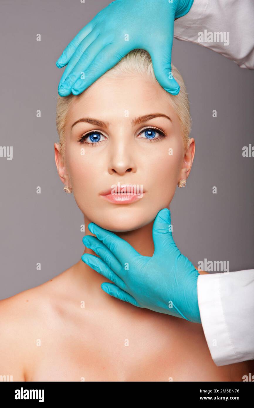 Cosmetic plastic surgeon touching aesthetics face Stock Photo