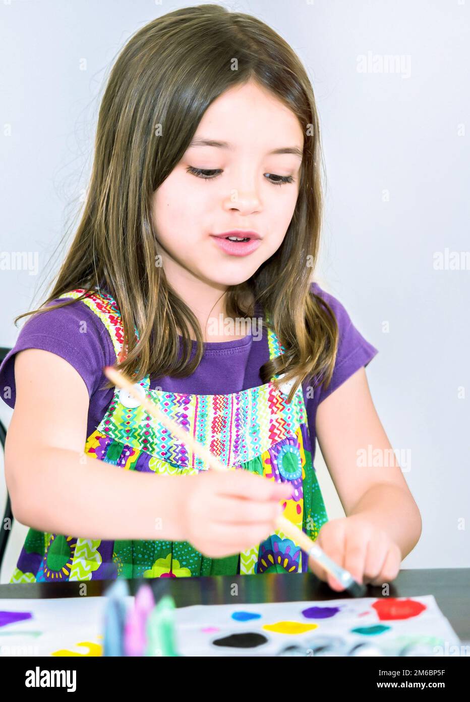 Portrait of a lovely smiling girl painting a picture Stock Photo - Alamy