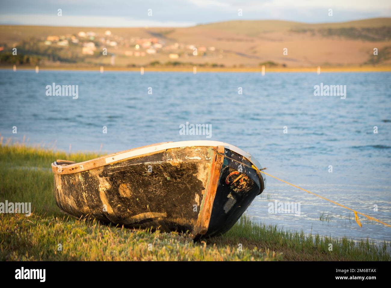 Old boat on river bank Stock Photo - Alamy