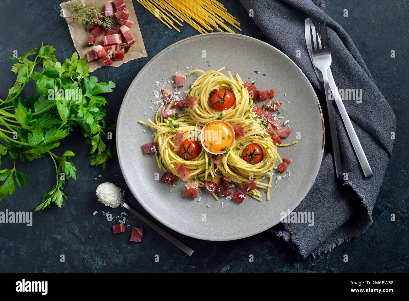 Hearty spaghetti in South Tyrolean style with bacon, egg yolk and
