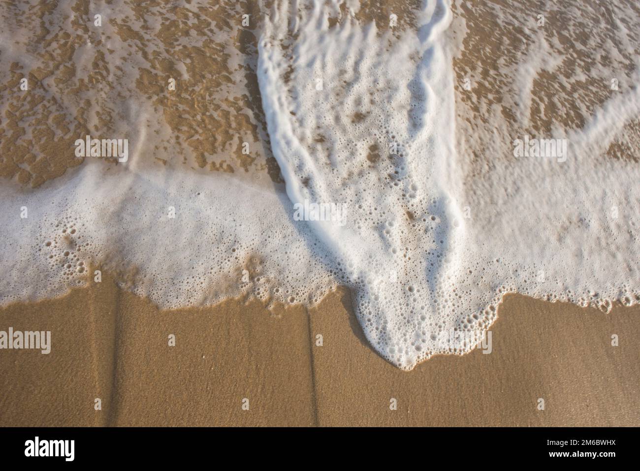 White Foam on Beach Stock Photo