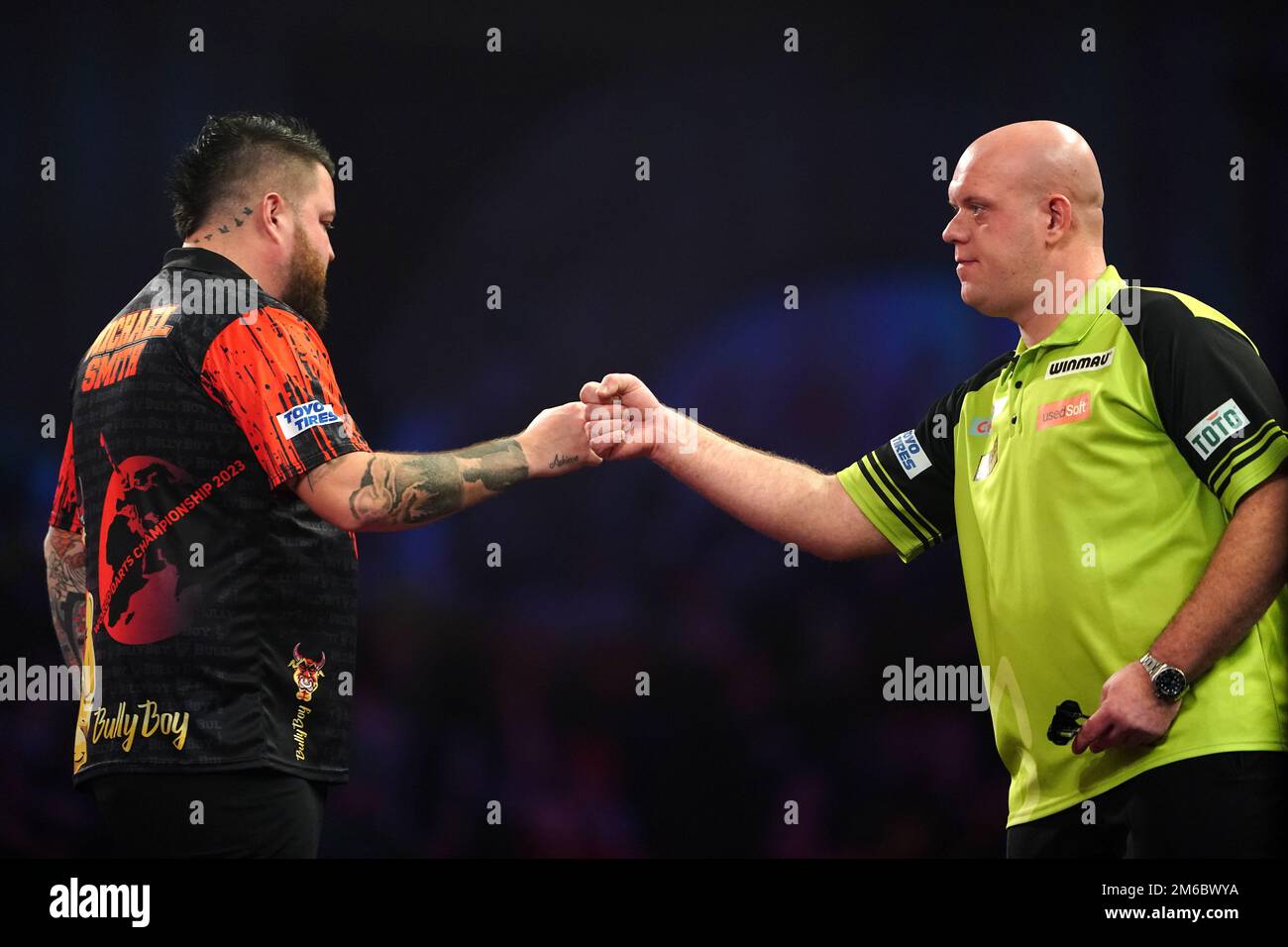 Michael Smith (left) is congratulated by Michael van Gerwen after