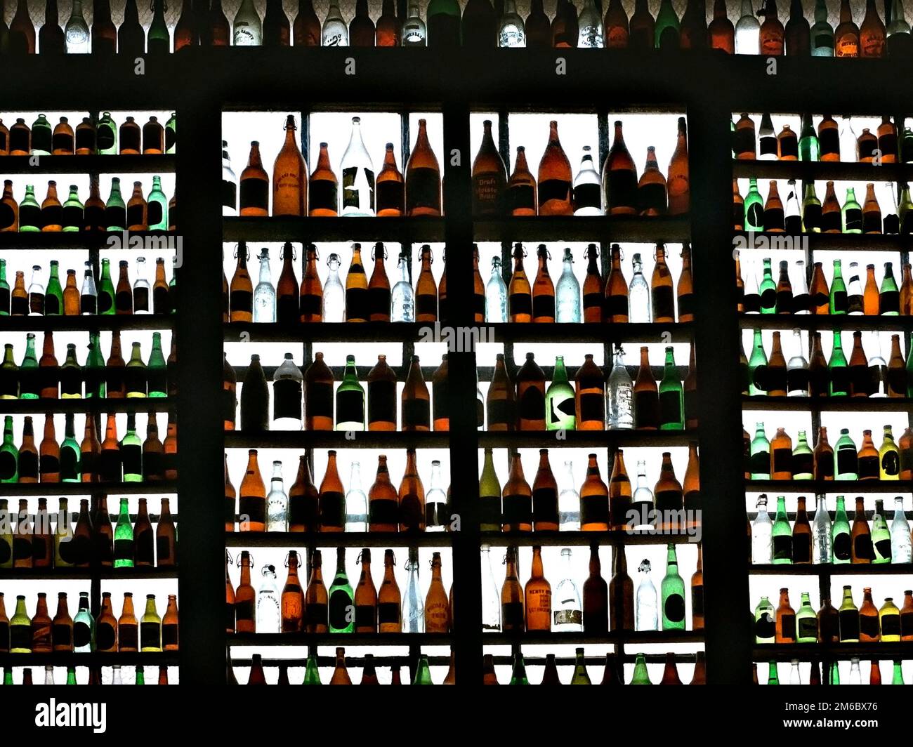 Backlit Collection of Beer Bottles on Shelves Stock Photo Alamy