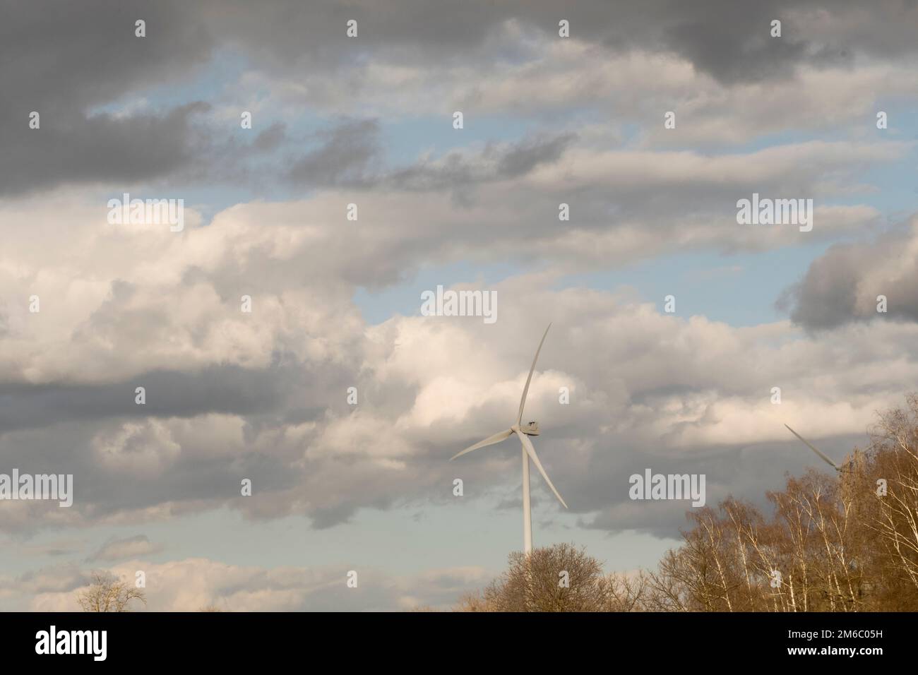 Energy windmill in a stormy spring sky Stock Photo