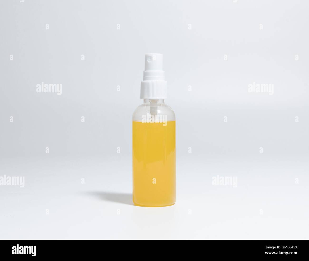 Spray Bottle with yellow liquid. close-up Stock Photo