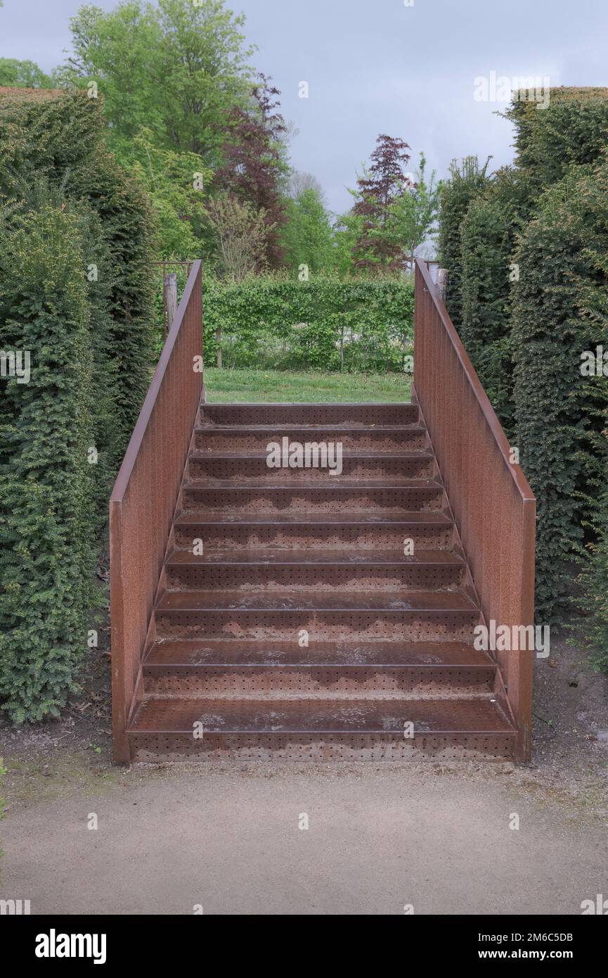 Iron rusty stairs in the park wet from the rain Stock Photo