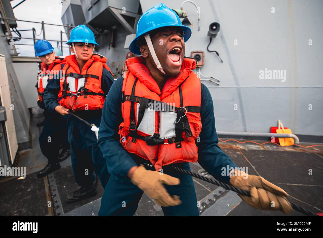 Philippine Sea. 31st Dec, 2022. U.S. Navy Retail Services Specialist Seaman Bryce Melton directs the phone and distance line team aboard the Arleigh Burke-class guided-missile destroyer USS Chung-Hoon (DDG 93) during an underway replenishment. Chung-Hoon, part of the Nimitz Carrier Strike Group, is currently underway in 7th Fleet conducting routine operations. 7th Fleet is the U.S. Navy's largest forward-deployed numbered fleet, and routinely interacts and operates with 35 maritime nations in preserving a free and open Indo-Pacific region. (Credit Image: © Andre Richard/U.S. Navy/ZUMA Pre Stock Photo