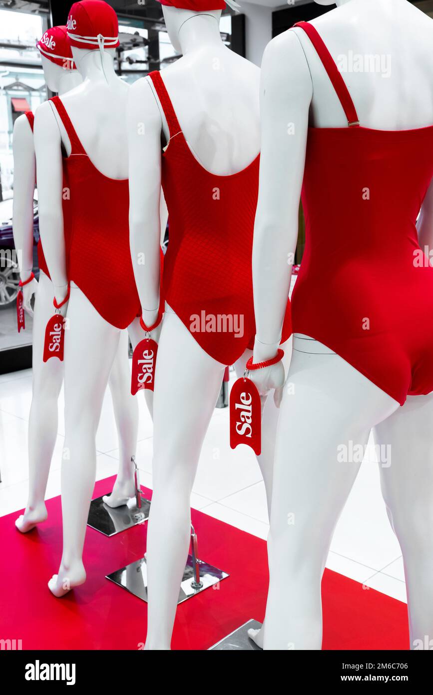 Series of mannequins in red swimsuits. Sale Stock Photo