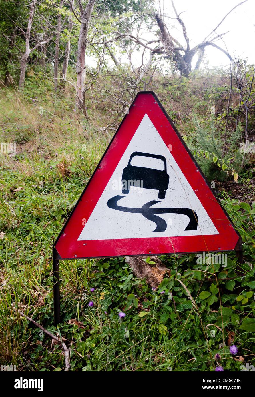 A red triangle driving sign on the side of road Stock Photo
