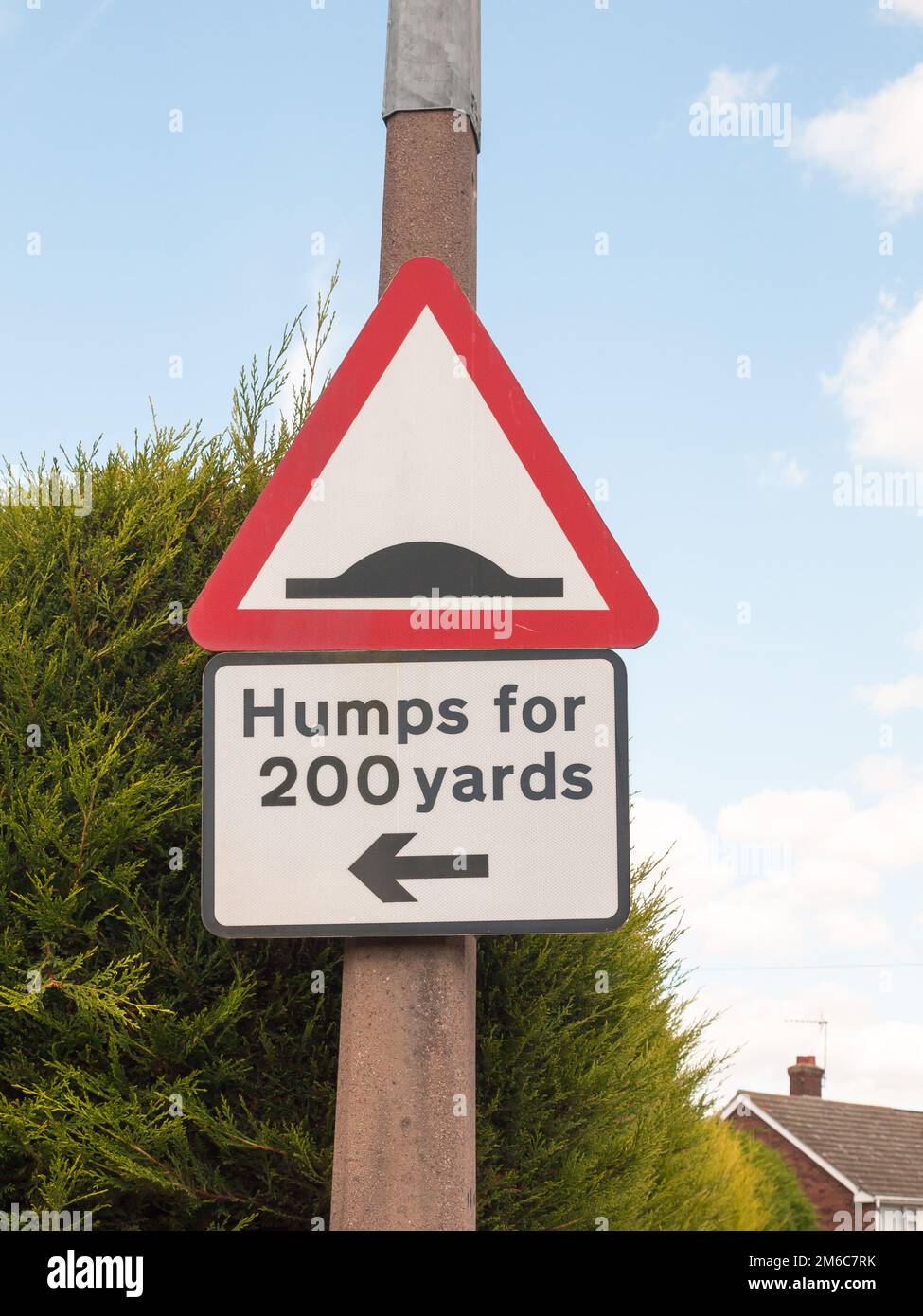 A traffic sign on a post outside humps for 200 yards direction pointer Stock Photo