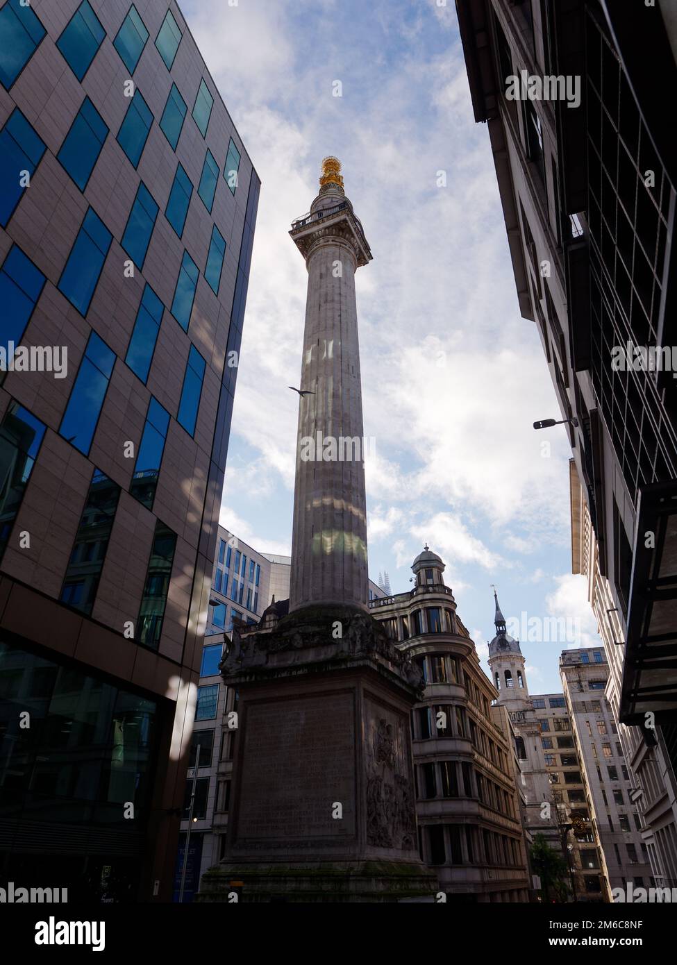 The Monument (To the Great Fire of London) in the City of London with surrounding architecture. Stock Photo