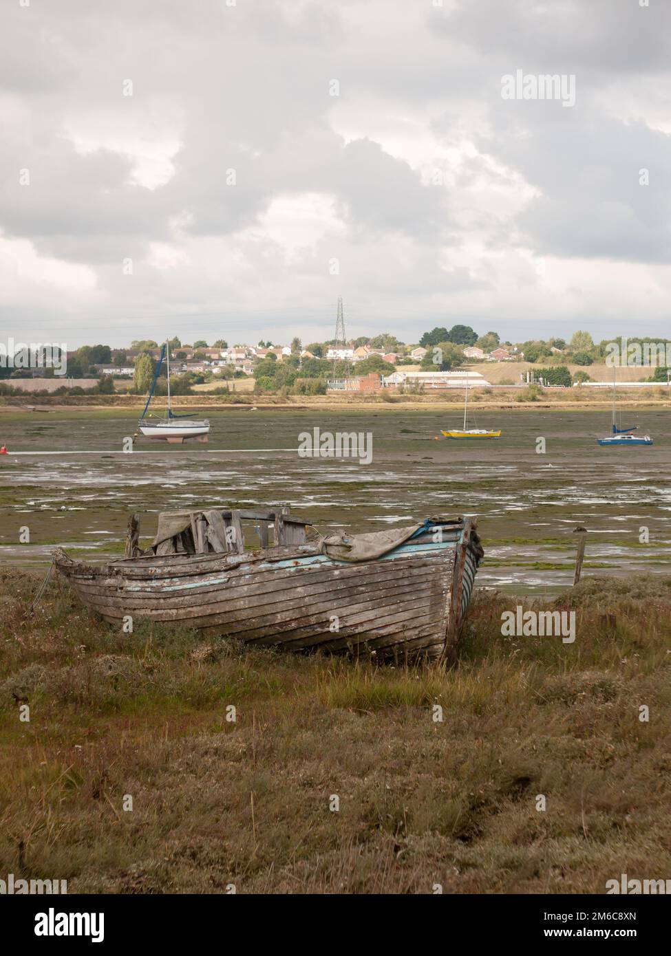 Old wooden boat ruins decaying abandoned estuary scene Stock Photo