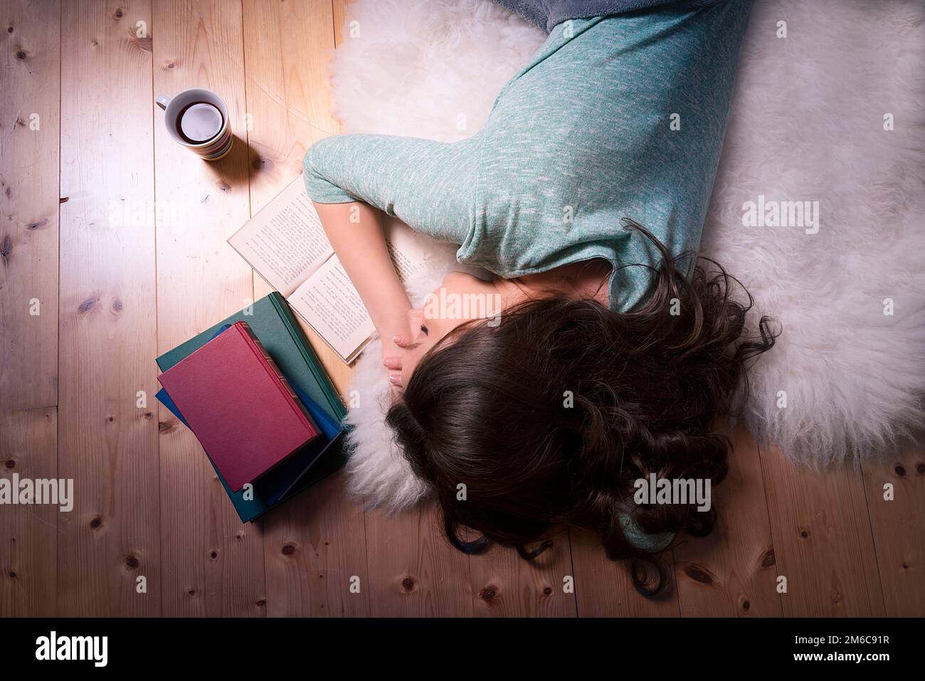 Young woman sleeping on an open book Stock Photo