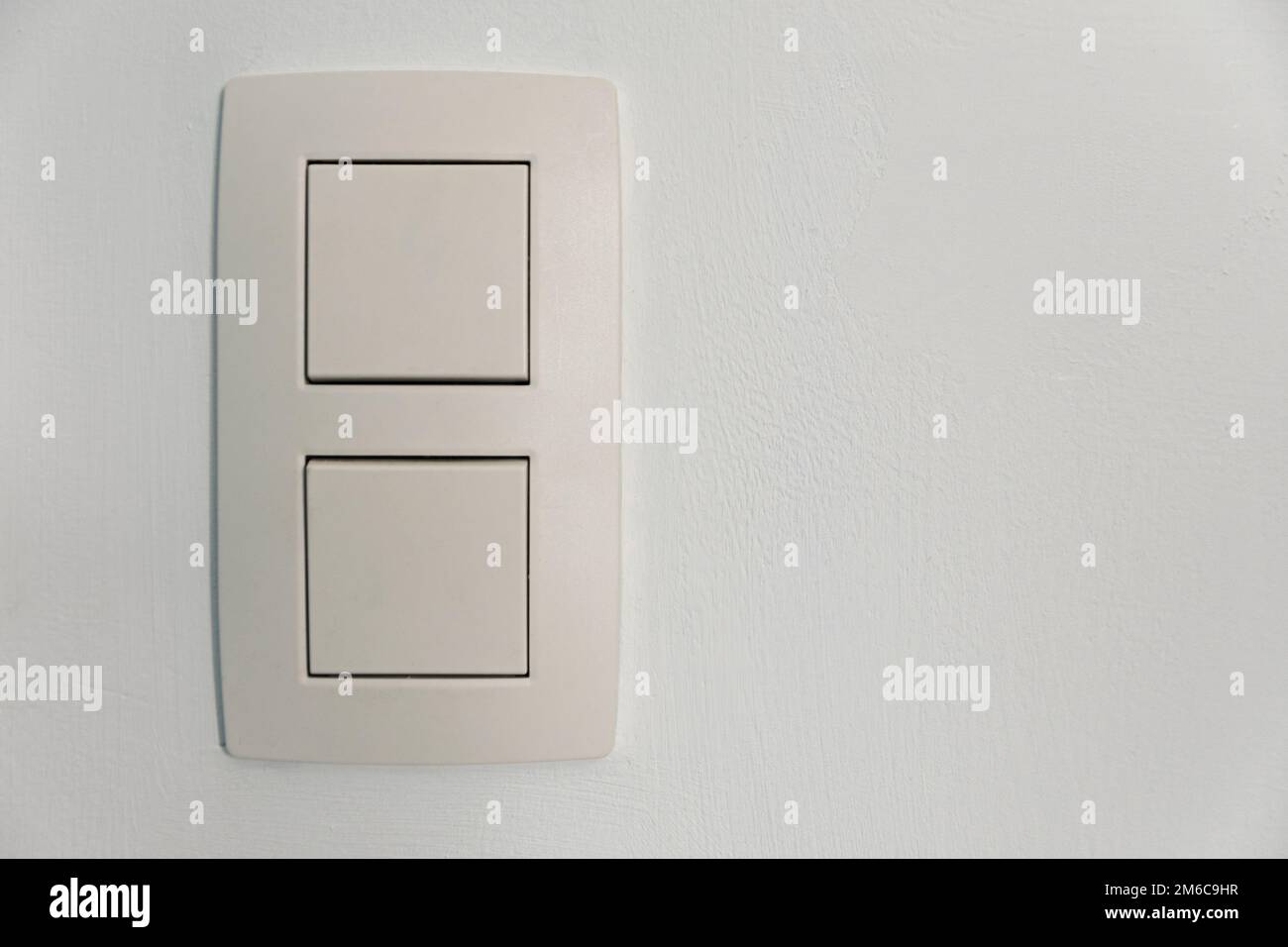 Standard double switch on a white wall, for use at home Stock Photo