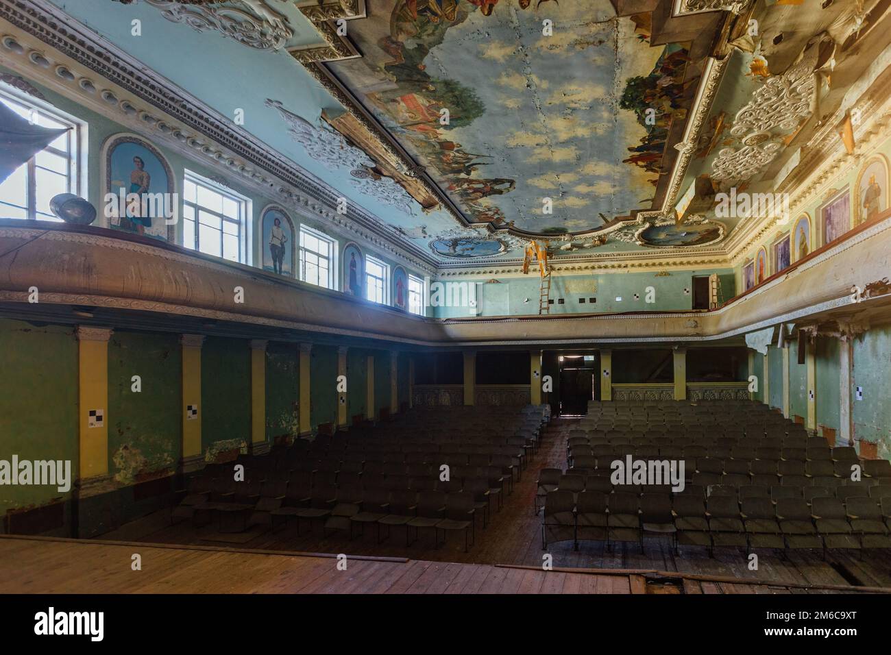 Old abandoned ruined stage theater with paintings. Stock Photo