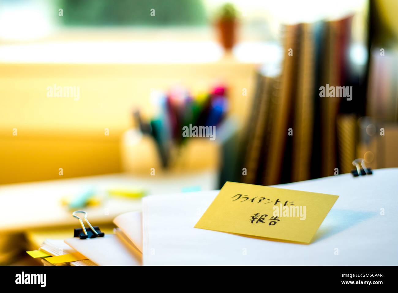 Report for Client; Stack of Documents. Working or Studying at messy desk. Stock Photo