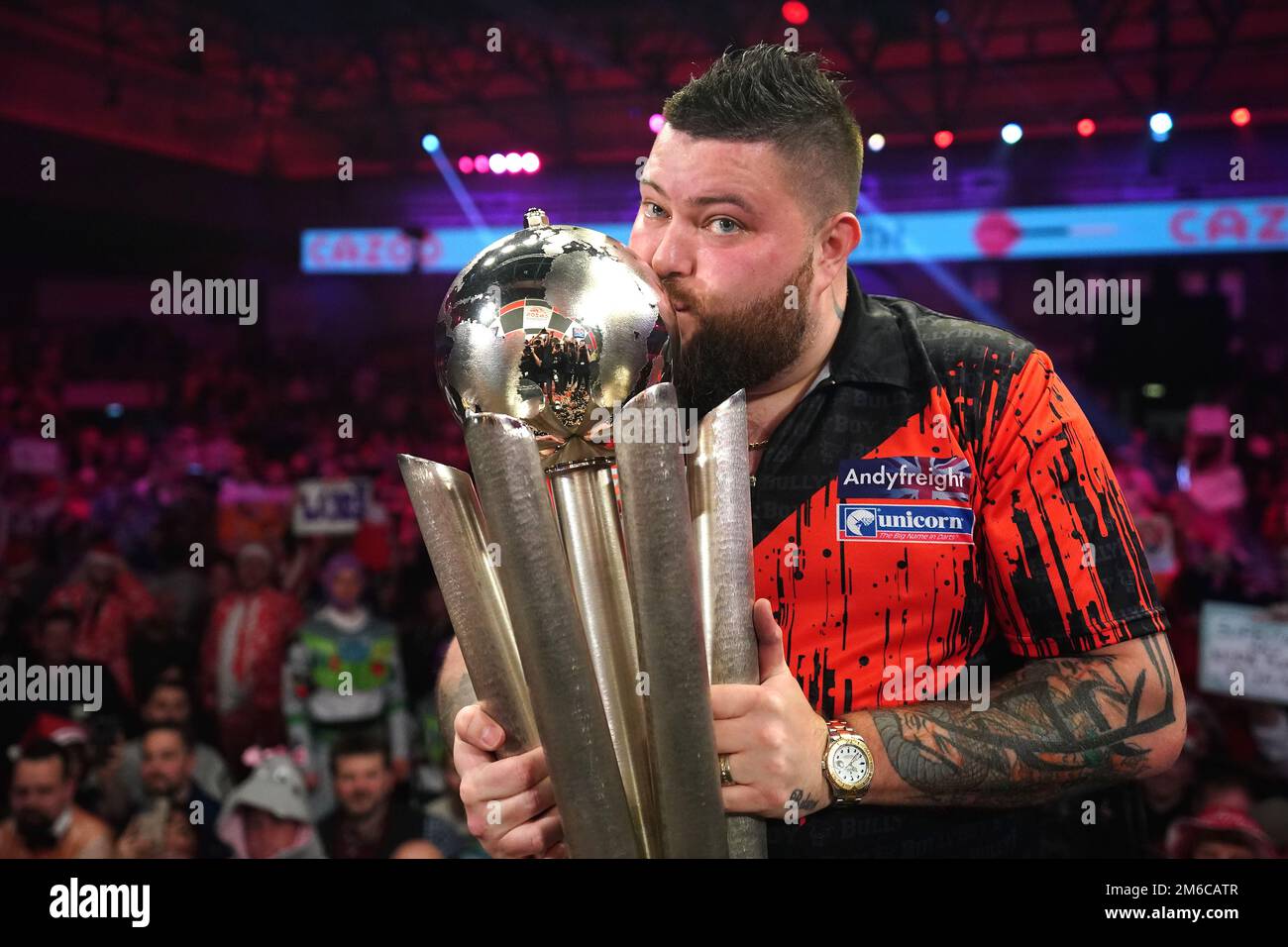 Michael Smith celebrates with the Sid Waddell trophy after winning the