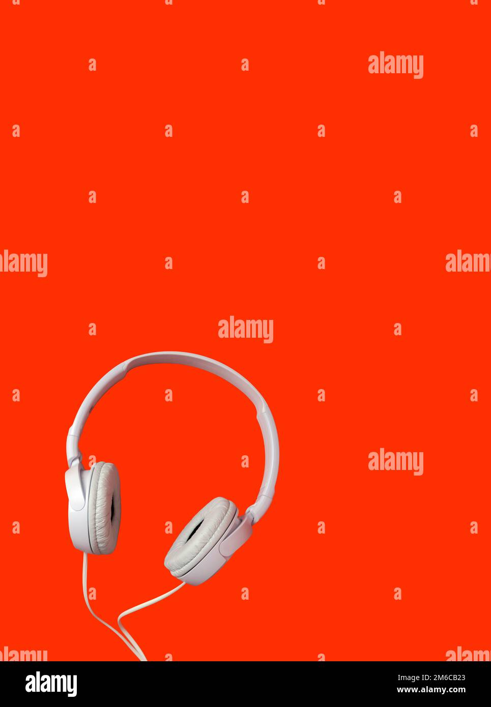 White headphones on a red background. Vertical Stock Photo Alamy