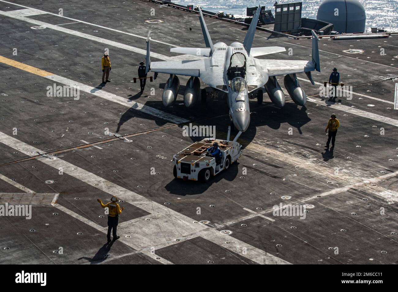 USS Nimitz, United States. 02 January, 2023. A U.S. Navy F/A-18E Super Hornet fighter aircraft from the Kestrels of Strike Fighter Squadron 146, dis towed across the flight deck of the Nimitz-class aircraft carrier USS Nimitz underway conducting routine operations, January 2, 2023 in the Philippine Sea.  Credit: MC3 Hannah Kantner/U.S Navy Photo/Alamy Live News Stock Photo