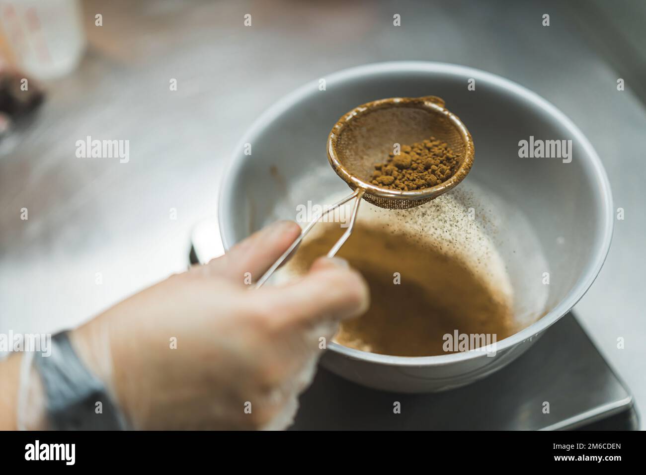 Small dredger with cocoa powder. Cooking and baking concept