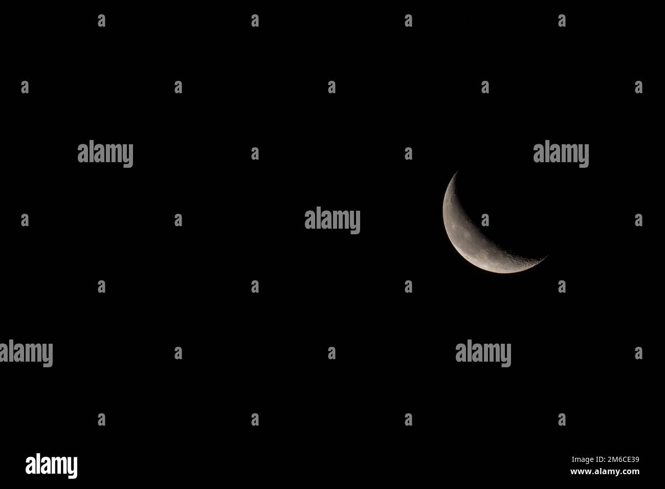 Waning Crescent Moon Landscape with copy space to left. Stock Photo