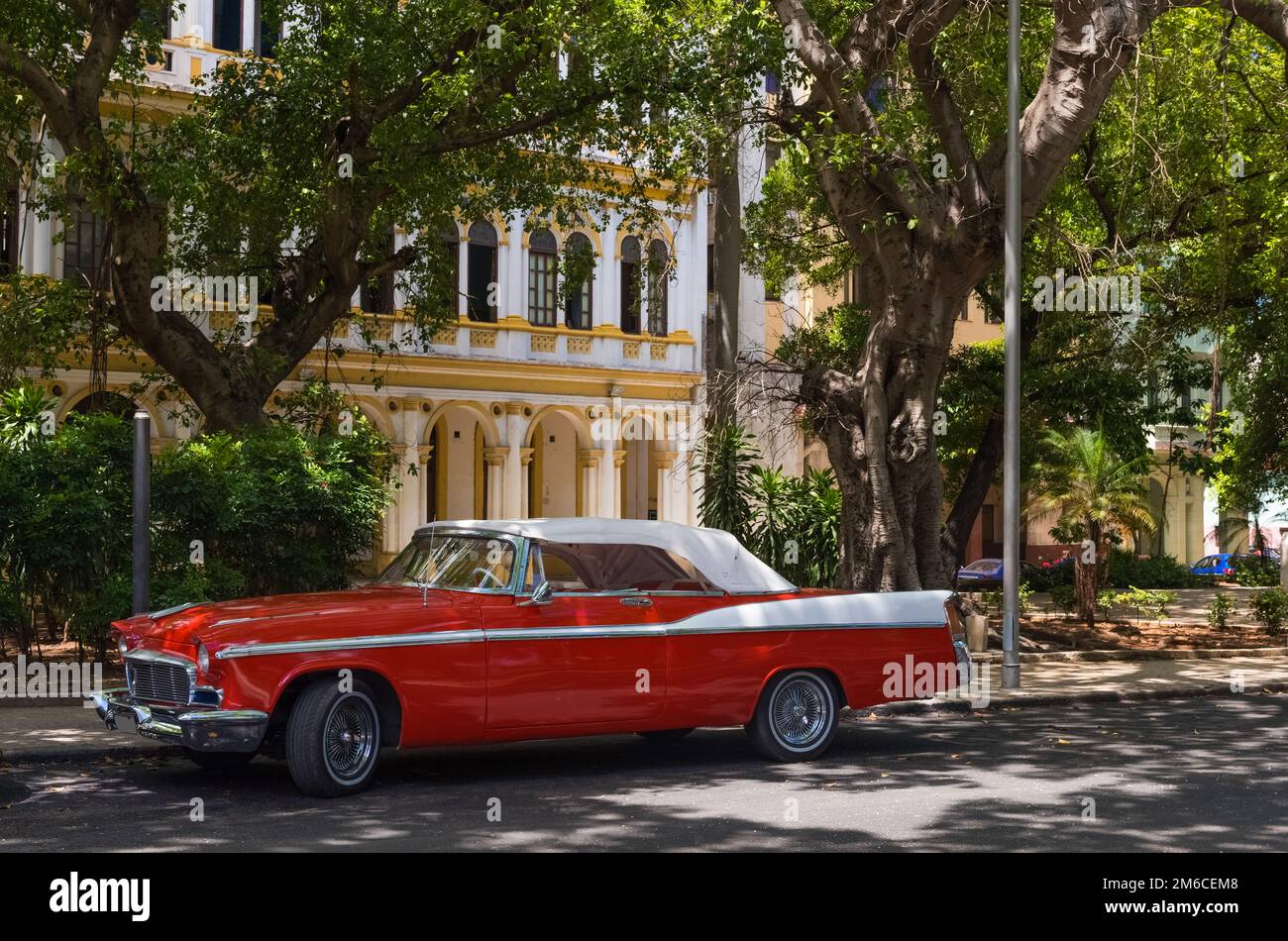 American red classic car with white roof parked on the side street in Havana Cuba - Serie C Stock Photo