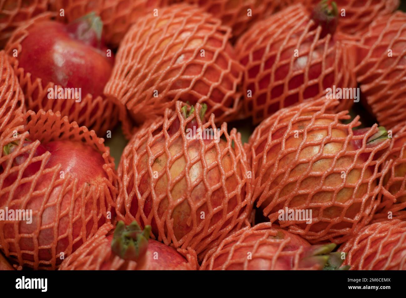 Pomegranate on market. Fruit in box. Fruits in net. Market Details