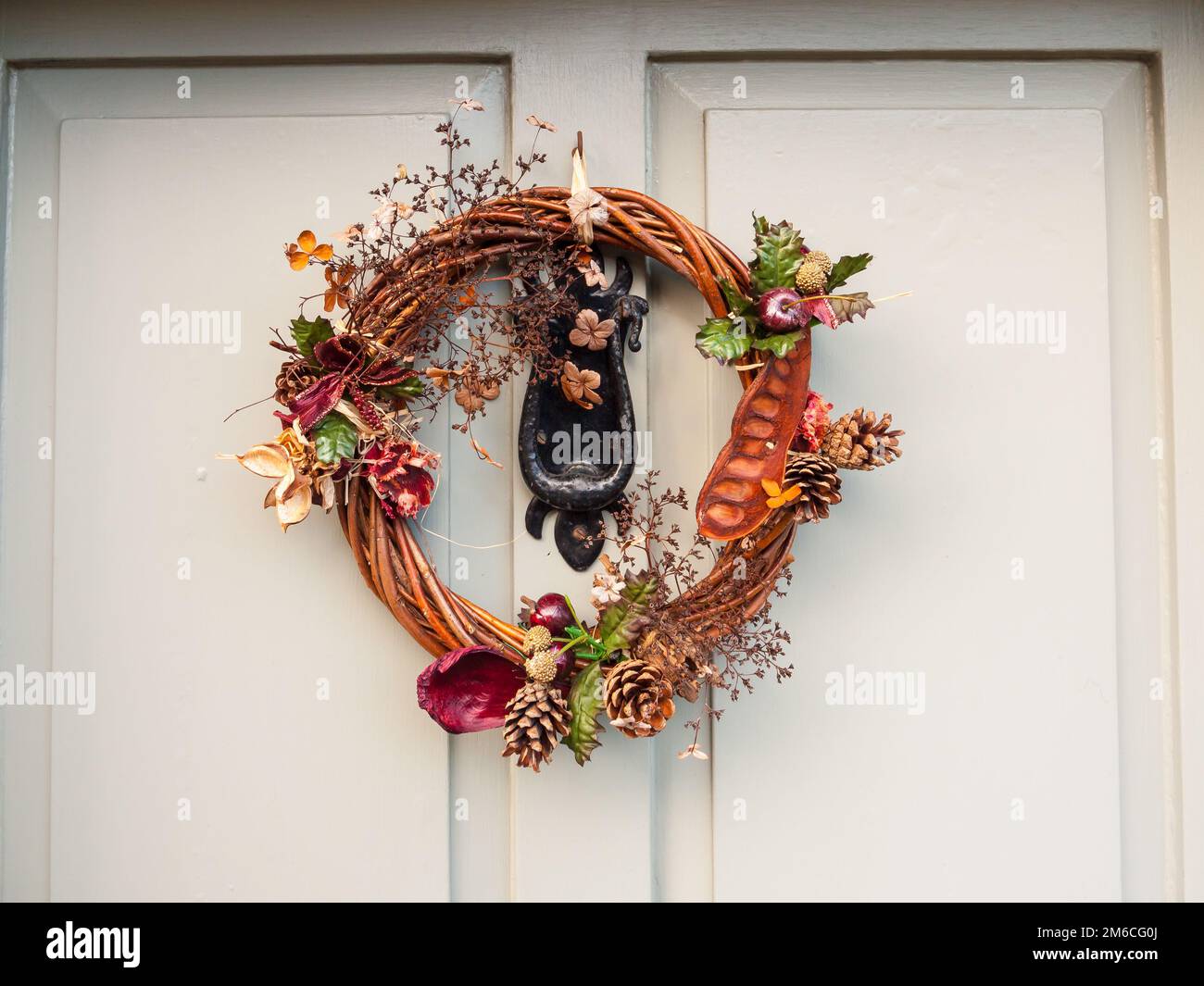 Beautiful christmas wreath on front of door hanging close up Stock Photo