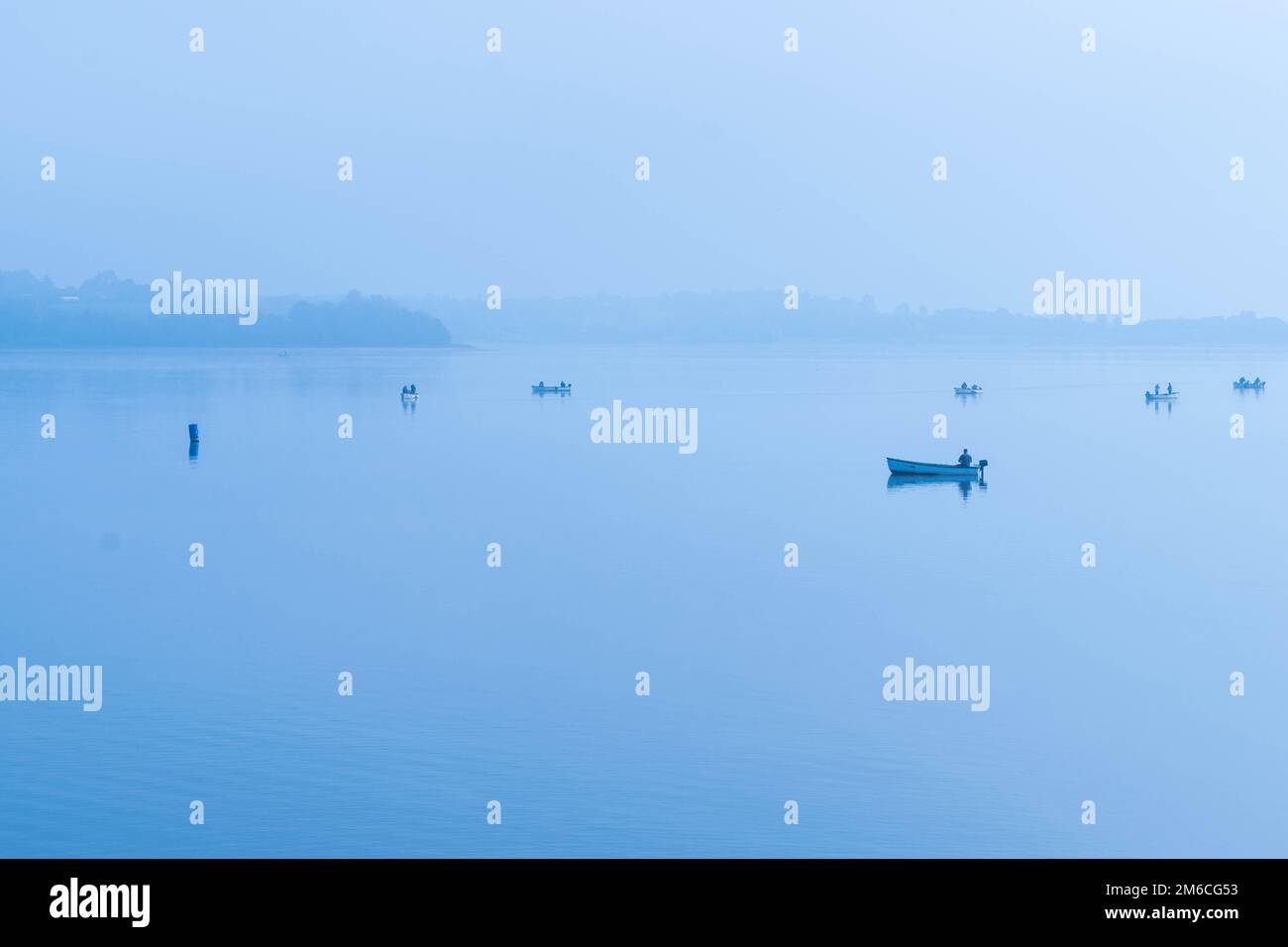 Fishing in the morning fog on the lake in Draycote waters, United Kingdom Stock Photo