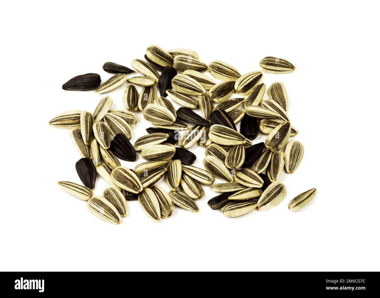 White and black sunflower seeds lying on a white background Stock Photo