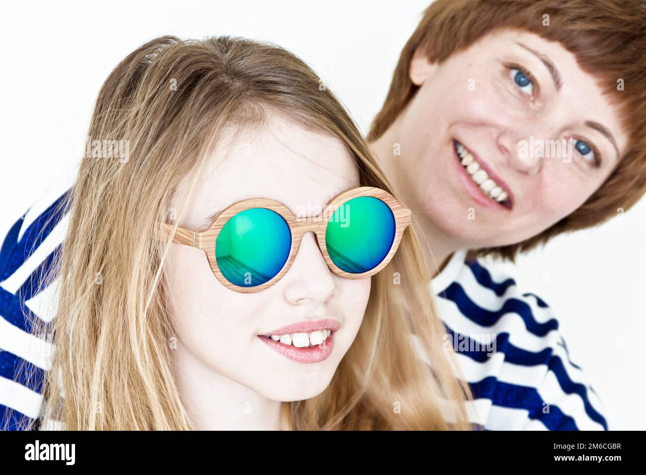 Beautiful mother and daughter on white Stock Photo - Alamy