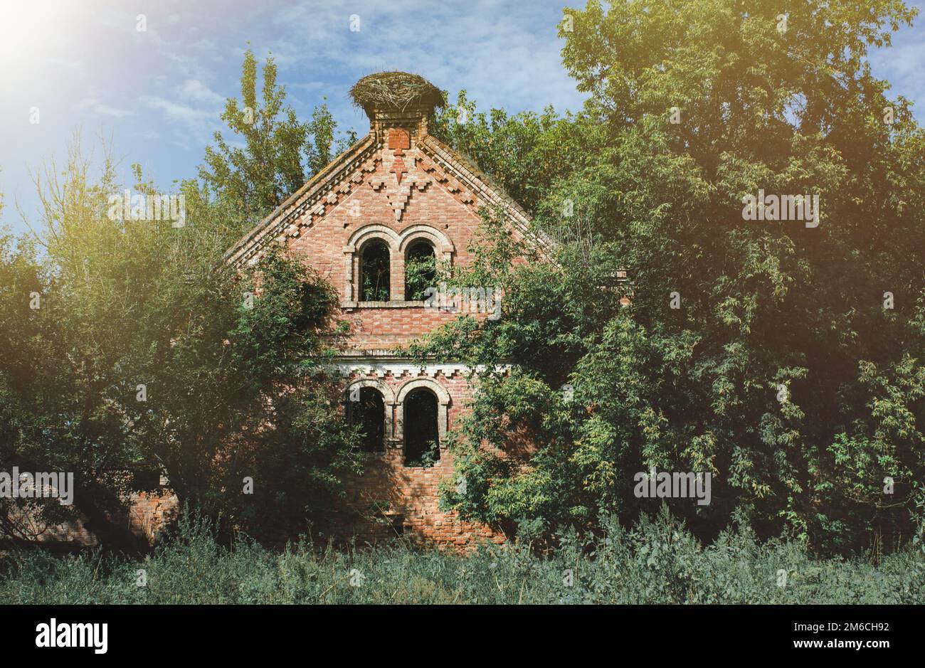 Abandoned and ruined Old brick mansion (house) in the forest Stock Photo