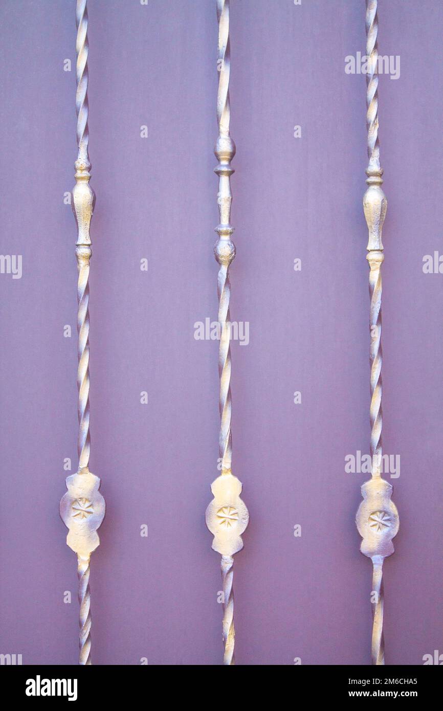 Metal patterns on a twisted metal rod on a purple background Stock ...