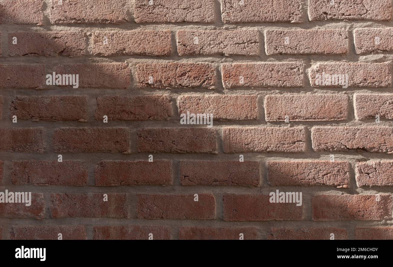 Direct diagonal sun shadow on brick wall texture Stock Photo