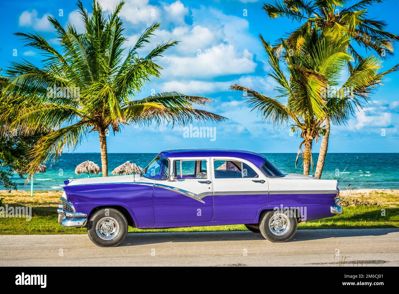 HDR - American blue white vintage car parked on the beach on the side strip in Havana Cuba - Serie C Stock Photo
