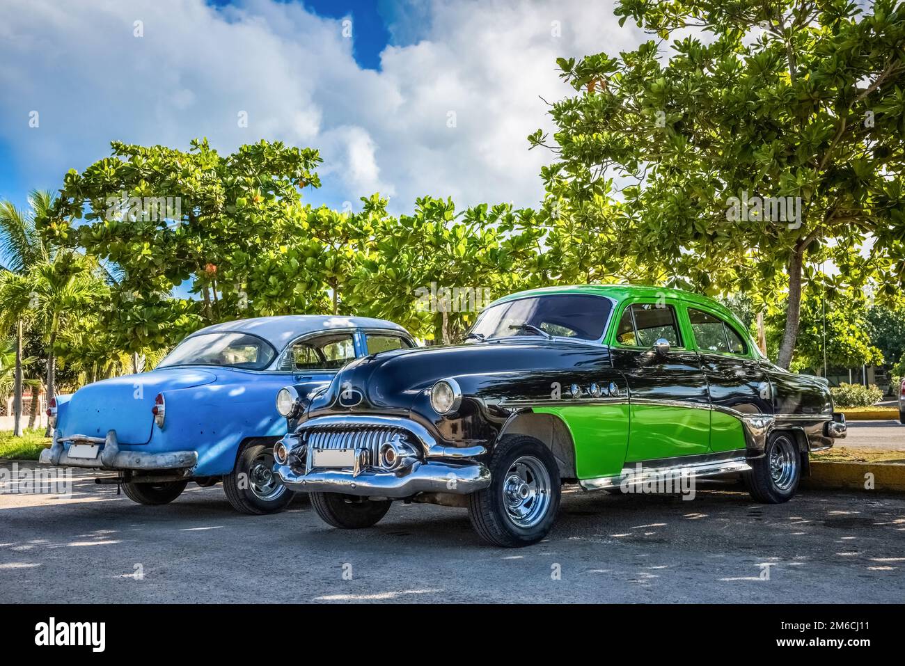 HDR - American black green and a blue vintage car parked in Varadero Cuba - Serie Cuba Reportage Stock Photo