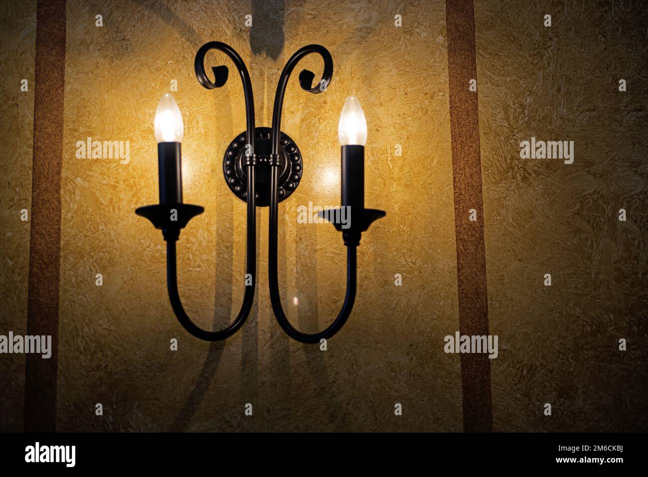 Decorative electric pendant on the wall. Stock Photo