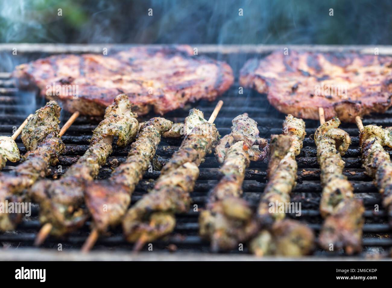 Meat on a charcoal grill Stock Photo - Alamy