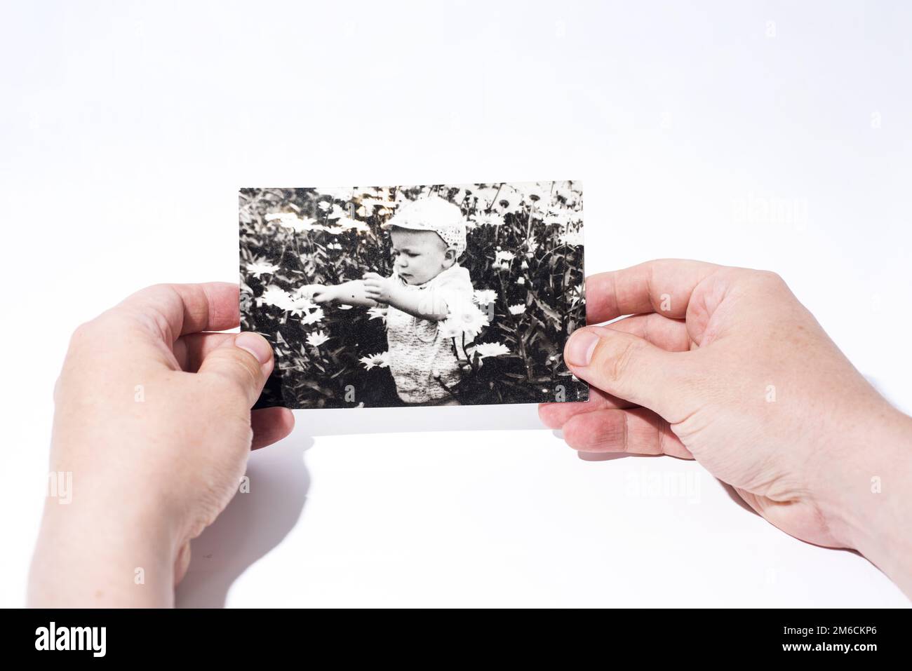 Old paper photo in mans hands. Stock Photo