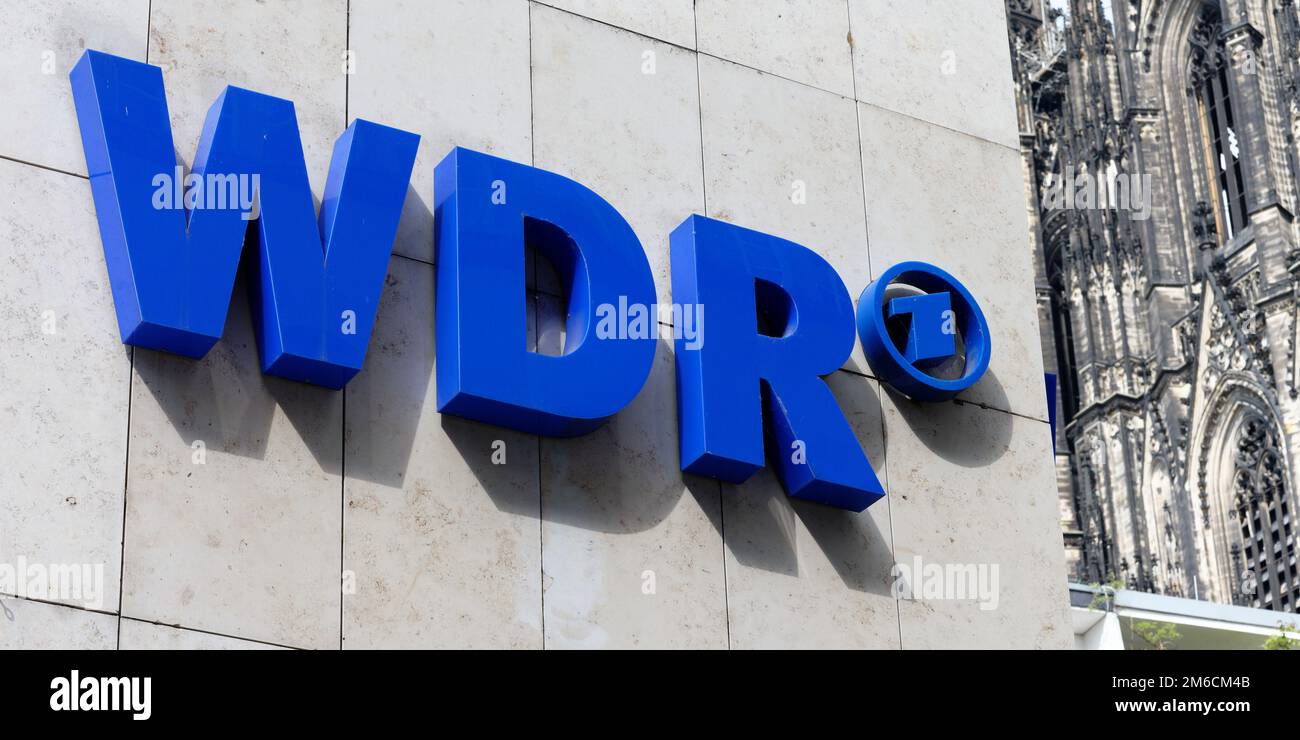 Cologne, Germany, April 30 2022: the wdr logo on the building of the West German Broadcasting Cologne with the cathedral in the background Stock Photo