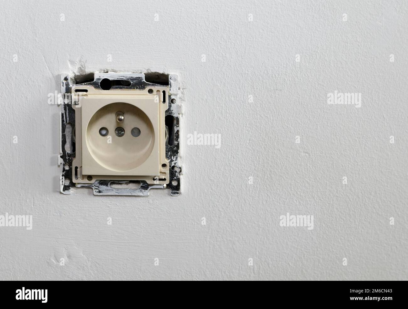 Framing cover from the socket. On the white wall Stock Photo