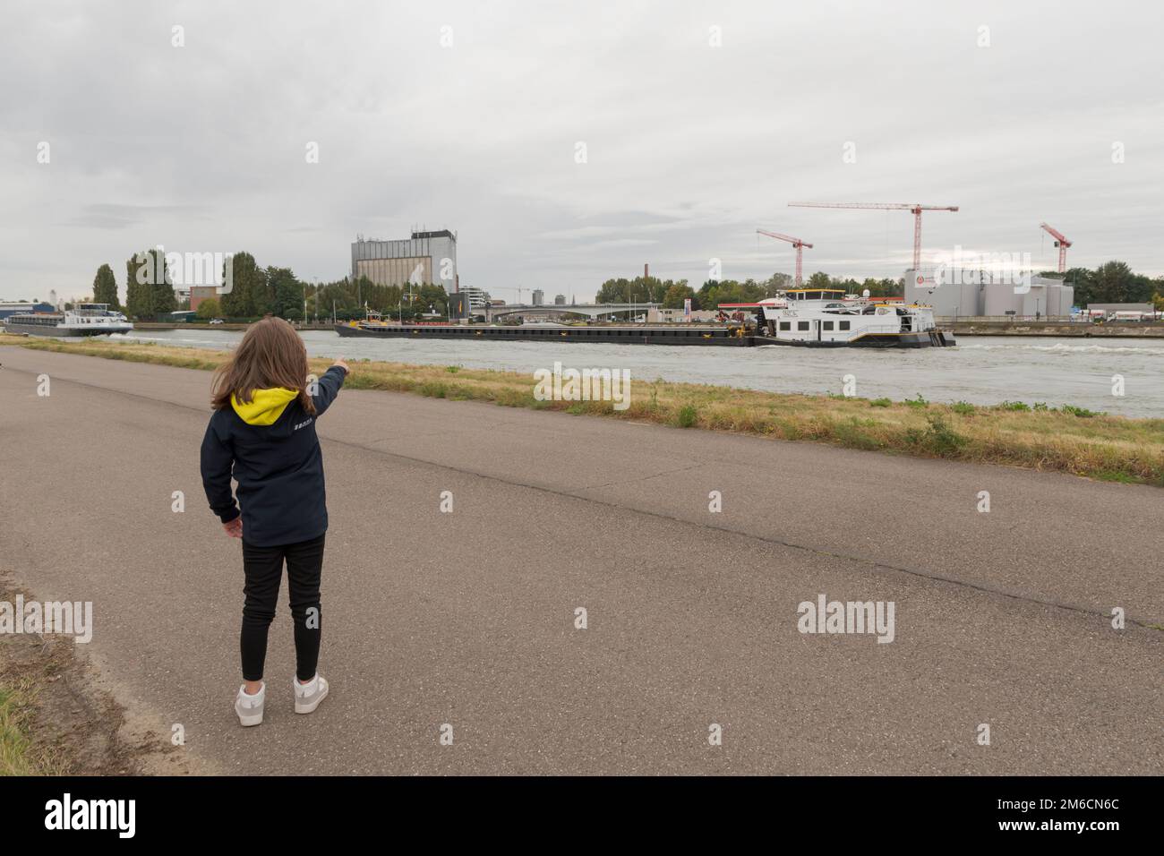 Hasselt, Limburg-Belgium 30-09-2021. View of the industrial zone. Teenage girl shows the new buildings in the city. Stock Photo