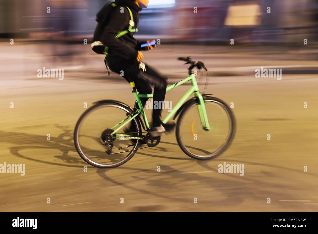 picture with intentional motion blur effect of a bicycle rider on a ...