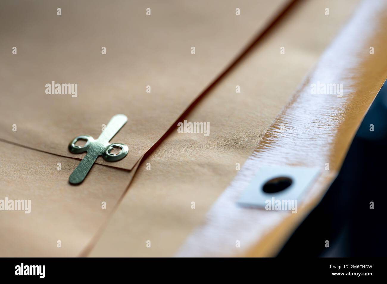 manilla envelope with reinforced hole and metal folding clasp Stock